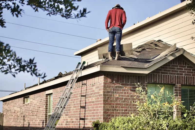 Professional roofer working on a residential roof in Calhoun Lake